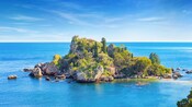 A body of water with trees and rocks on Isola Bella near Sicily, Italy