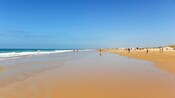 Guests walking along the shores of a beach near Conil de la Frontera