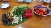 A variety of mixing bowls filled with fresh produce and other ingredients