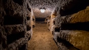 Um túnel nas catacumbas de Roma iluminado com uma luz