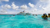 A catamaran floating in clear water with a snorkeling tour