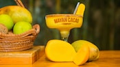 Mangos next to a mango margarita with a salted rim at The Mayan Cacao Company in Cozumel, Mexico