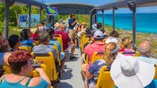 A tour group on a bus traveling through Cozumel