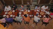 A family chats together while waiting for a meal in La Cava de Marcelo