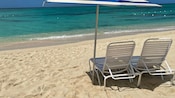 Two chairs and an umbrella on a beach in Falmouth, Jamaica