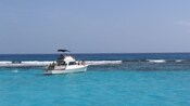 A power boat floating on the water off the coast of George Town in Grand Cayman
