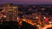 A time lapse photo of the Hamburg skyline and cars on roadways at dusk