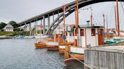 House boats on the water next to a bridge in Haugesund, Norway