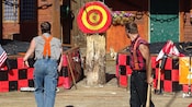 2 lumberjacks competing in an axe throwing contest