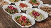 6 bowls filled with a variety of Greek cuisine