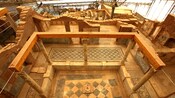 An archaeological site featuring mosaic floors and columns