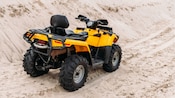 An ATV parked on a sandy trail