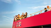 Guests taking photos from the second story of a double decker bus in Florence, Italy