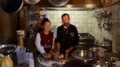 2 people kneading dough in a kitchen