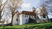 A medieval monastery on a grassy hillside