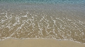 A shoreline along Ornos beach near Mykonos in Greece