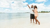 A couple smiling and standing on the beach in Nassau in The Bahamas
