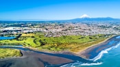 An aerial view of New Plymouth with Mount Taranaki in the distance
