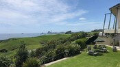 A lawn at a winery next to a body of water
