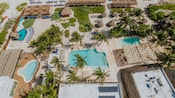 A beach resort with pools, beach chairs and umbrellas