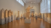 Rows of Greek statues in a museum in Athens, Greece