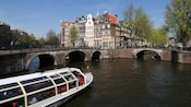 A sightseeing boat gliding through a canal