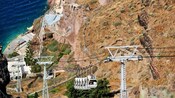 Cable cars traveling alongside a steep mountain