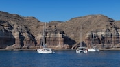A catamaran floating in a lagoon near Santorini, Greece