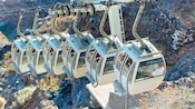 Cable cars traveling alongside a steep mountain
