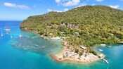 An aerial view of an island with a beach and boats in the water at Marigot Bay in Saint Lucia