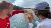 Two Guests on a boat, piecing together a map of Saint Thomas
