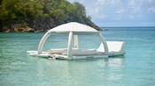 A floating cabana in the waters of a tropical beach