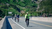 People riding bicycles on a road in Skagway, Alaska