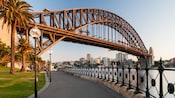 A waterfront promenade beneath the Sydney Harbour Bridge