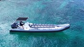 A long, multi passenger power boat on the water