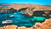 Catamarans and small boats at the Blue Lagoon in Malta