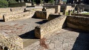 Stone ruins of the Taurine Baths near trees in Civitavecchia, Italy
