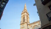 The Cathedral Basilica of Saint James with intricate stonework and a clock in Bilbao, Spain