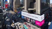 The New York Marriott Marquis Hotel standing tall over the busy city street  
