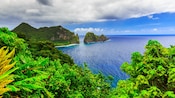 A lush island overlooking the water with verdant rock formations