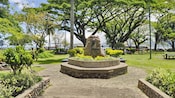 A stone monument inside a verdant park