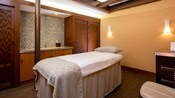 A plush massage bed in a private room at Senses Spa and Salon aboard a Disney ship 