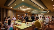 An artist rendering of chefs cooking in front of Guests at hibachi grills at Mike & Sully’s on the Disney Adventure