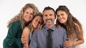 A portrait photo taken at Disney Studio of a smiling family of 4