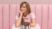 Erin McKenna sitting at a table with a cake