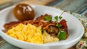Scrambled Eggs served over Mascarpone Polenta with a Sweet Brioche Roll served with Bacon and Italian Sausage