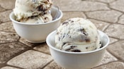 Two small dishes, each holding scoops of cookies and cream gelato