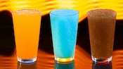 Three glasses with orange, blue and brown colored Frozen Slushies from Astrofizz