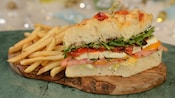 A caprese sandwich served with an order of fries