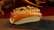 A California BLTA Dog topped with fresh vegetables and crispy bacon